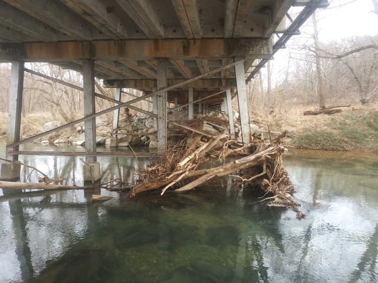 Image of Bridge with trash accumulating underneath